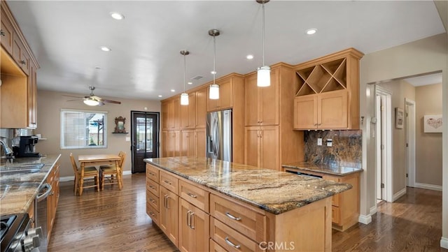 5215 E Monlaco Rd, Long Beach, CA 90808 - kitchen with appliances with stainless steel finishes, a kitchen island, decorative backsplash, dark wood-style flooring, and recessed lighting