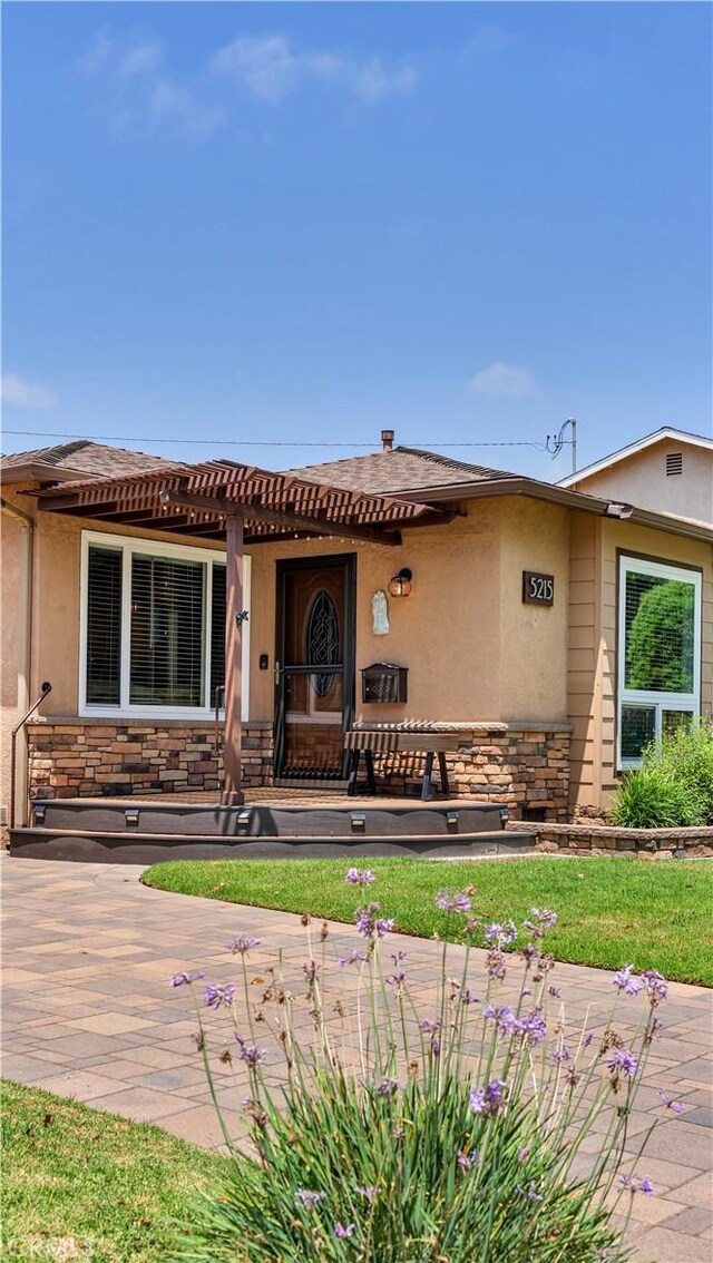 5215 E Monlaco Rd, Long Beach, CA 90808 - view of front of home with stone siding and stucco siding
