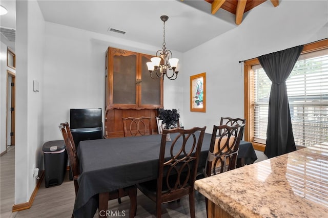 6739 Palm Ave, Riverside, CA 92506 - dining area with a chandelier, light wood finished floors, and beam ceiling