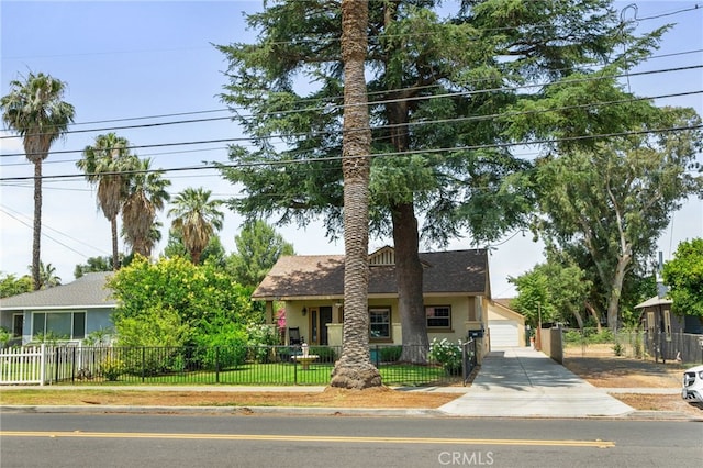 6739 Palm Ave, Riverside, CA 92506 - view of property hidden behind natural elements featuring stucco siding, a fenced front yard, a shingled roof, and a garage