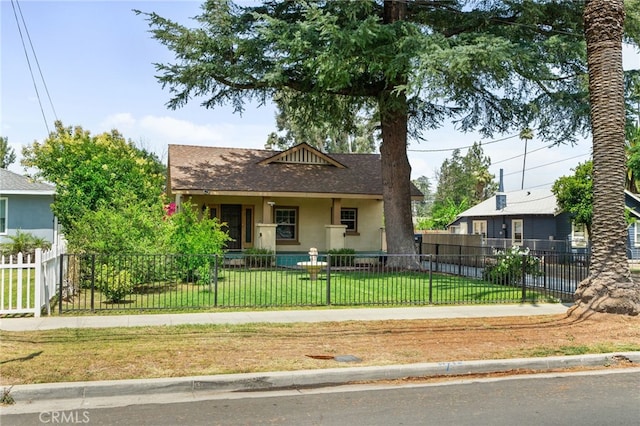 6739 Palm Ave, Riverside, CA 92506 - bungalow with roof with shingles, stucco siding, a fenced front yard, and covered porch