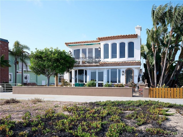 1201 E Balboa Blvd, Newport Beach, CA 92661 - rear view of property with a fenced front yard, a tiled roof, a chimney, stucco siding, and a gate