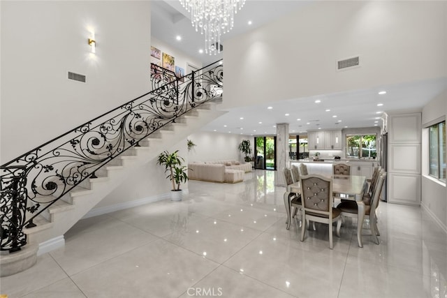 6355 Yolanda Ave, Tarzana, CA 91335 - dining area with light tile patterned flooring, a high ceiling, stairs, a chandelier, and recessed lighting