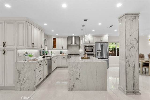 6355 Yolanda Ave, Tarzana, CA 91335 - kitchen with stainless steel appliances, wall chimney range hood, light stone countertops, recessed lighting, and a kitchen island