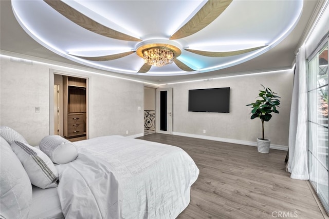 6355 Yolanda Ave, Tarzana, CA 91335 - bedroom featuring wood finished floors, a raised ceiling, and a ceiling fan