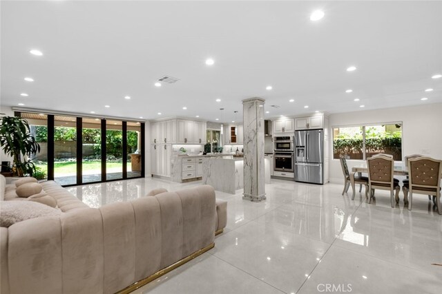 6355 Yolanda Ave, Tarzana, CA 91335 - living room featuring light tile patterned floors, recessed lighting, and ornate columns