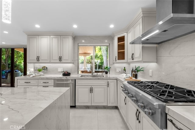 6355 Yolanda Ave, Tarzana, CA 91335 - kitchen featuring wall chimney range hood, stainless steel appliances, decorative backsplash, recessed lighting, and light stone countertops