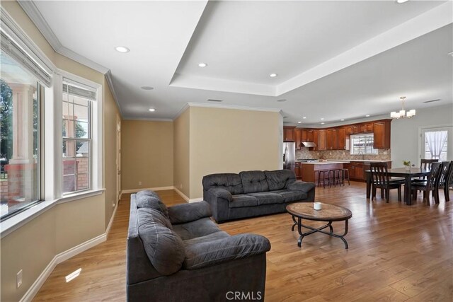18651 E Weather Rd, Covina, CA 91722 - living room with recessed lighting, light wood-style flooring, a chandelier, a tray ceiling, and ornamental molding