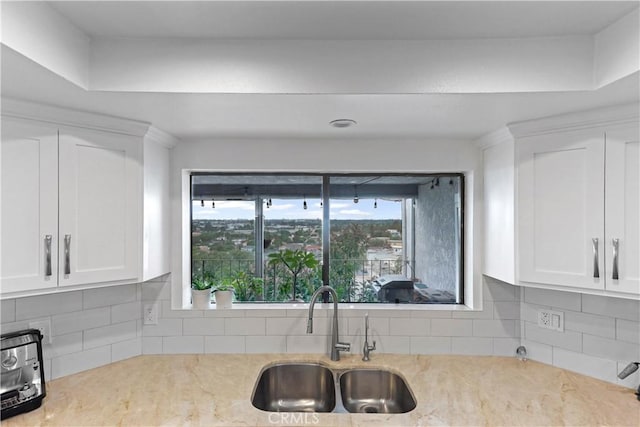 1995 Molino Ave Unit 102, Signal Hill, CA 90755 - kitchen featuring decorative backsplash, white cabinets, and light stone countertops