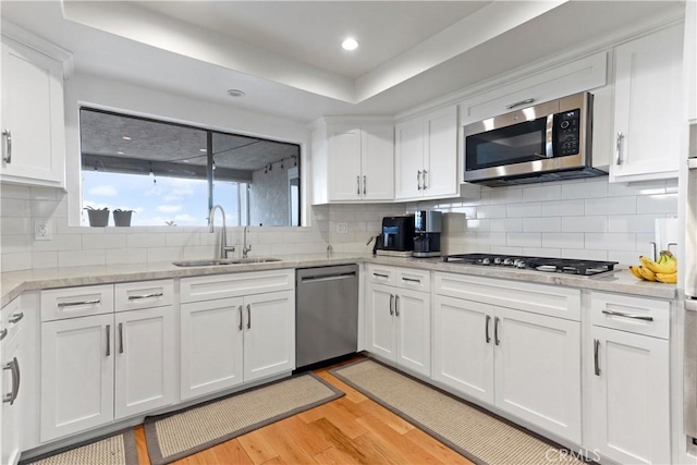 1995 Molino Ave Unit 102, Signal Hill, CA 90755 - kitchen featuring appliances with stainless steel finishes, light wood-style floors, white cabinets, decorative backsplash, and recessed lighting