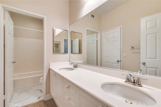 13711 Hidden, Eastvale, CA 92880 - bathroom with double vanity, marble look tiles, and bathtub / shower combination