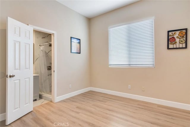 13711 Hidden, Eastvale, CA 92880 - unfurnished bedroom featuring light wood-style floors and ensuite bathroom