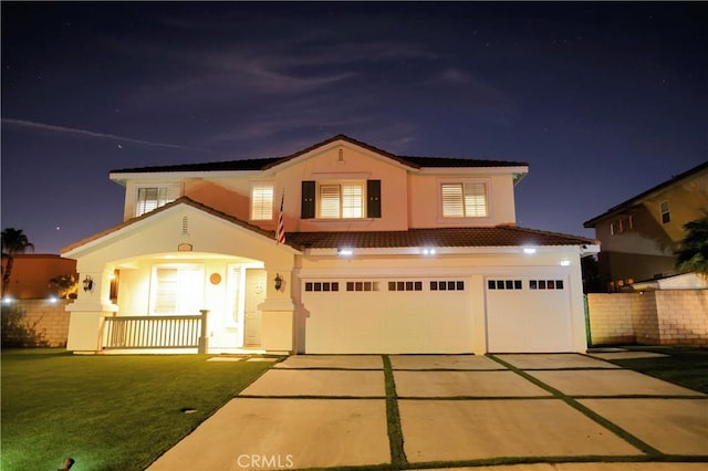 12170 Orgren Ave, Chino, CA 91710 - view of front of house with an attached garage, concrete driveway, stucco siding, a porch, and a lawn