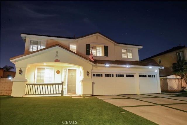 12170 Orgren Ave, Chino, CA 91710 - view of front of home featuring driveway, an attached garage, stucco siding, a porch, and a yard