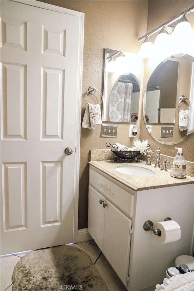 12170 Orgren Ave, Chino, CA 91710 - bathroom with tile patterned flooring, vanity, and a textured wall