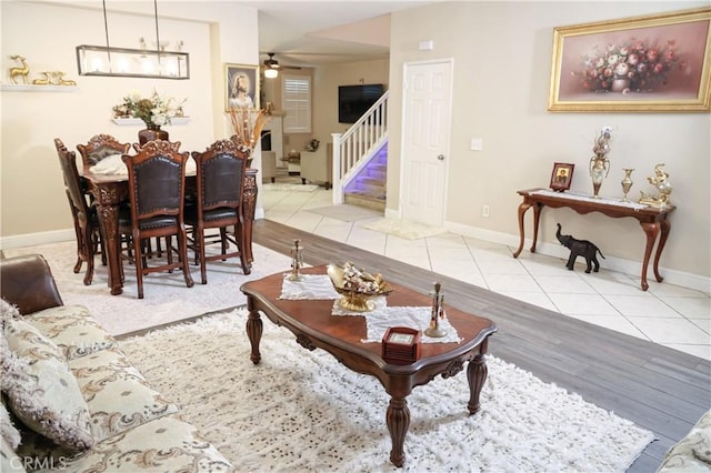 12170 Orgren Ave, Chino, CA 91710 - tiled living room featuring stairway and ceiling fan
