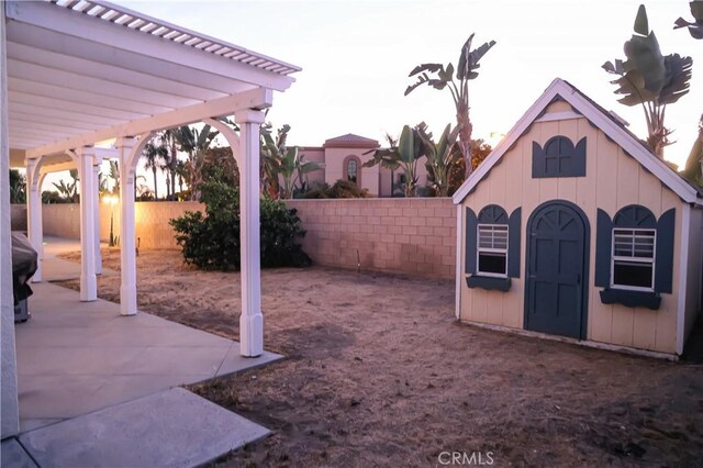 12170 Orgren Ave, Chino, CA 91710 - fenced backyard featuring a pergola, a patio area, and an outdoor structure