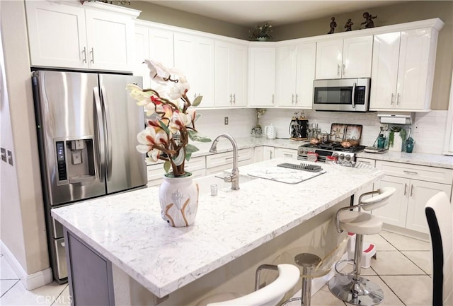 12170 Orgren Ave, Chino, CA 91710 - kitchen with stainless steel appliances, light tile patterned flooring, and white cabinets