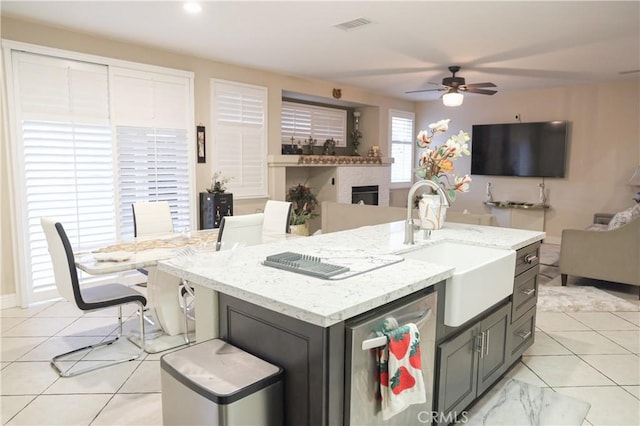 12170 Orgren Ave, Chino, CA 91710 - kitchen featuring open floor plan, light tile patterned flooring, ceiling fan, and light stone counters