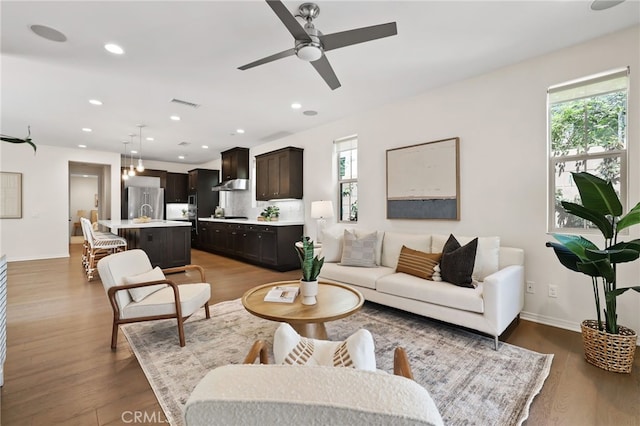 143 Hollow Tree, Irvine, CA 92618 - living area with a ceiling fan, wood finished floors, and recessed lighting
