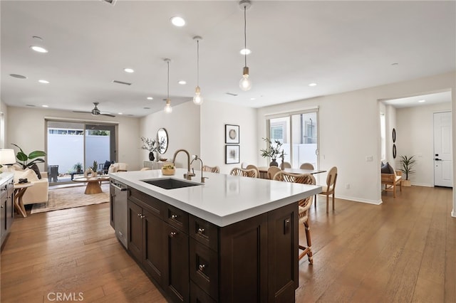 143 Hollow Tree, Irvine, CA 92618 - kitchen with ceiling fan, a breakfast bar area, open floor plan, light countertops, and dark brown cabinetry
