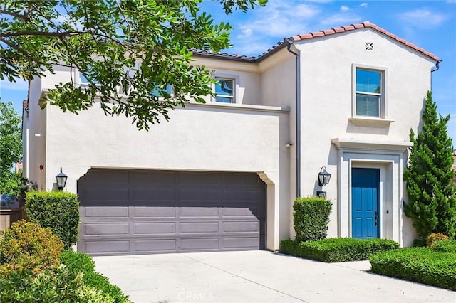 143 Hollow Tree, Irvine, CA 92618 - mediterranean / spanish-style home featuring stucco siding, an attached garage, driveway, and a tile roof