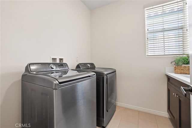 143 Hollow Tree, Irvine, CA 92618 - washroom with cabinet space, washer and dryer, and light tile patterned floors