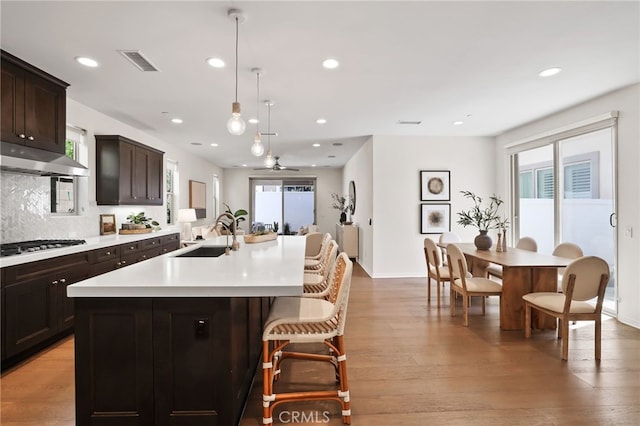 143 Hollow Tree, Irvine, CA 92618 - kitchen with light countertops, a center island with sink, healthy amount of natural light, recessed lighting, and light wood-type flooring