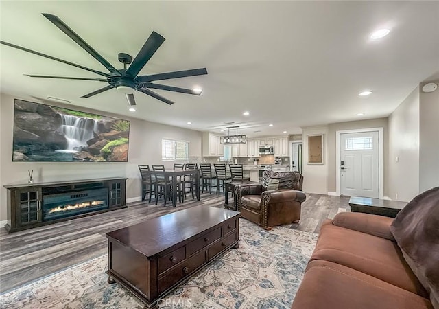 2288 Marilyn St, Simi Valley, CA 93065 - living room with wood finished floors, ceiling fan, recessed lighting, healthy amount of natural light, and a glass covered fireplace
