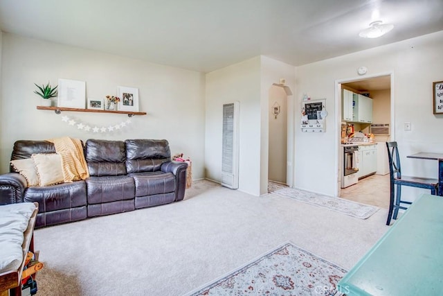 12029 Greyford St, Whittier, CA 90606 - living area featuring a heating unit, arched walkways, and light carpet