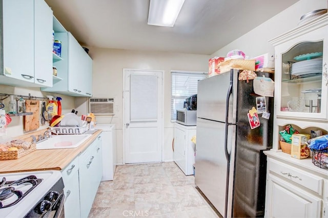 12029 Greyford St, Whittier, CA 90606 - kitchen with freestanding refrigerator, white microwave, light countertops, open shelves, and gas range