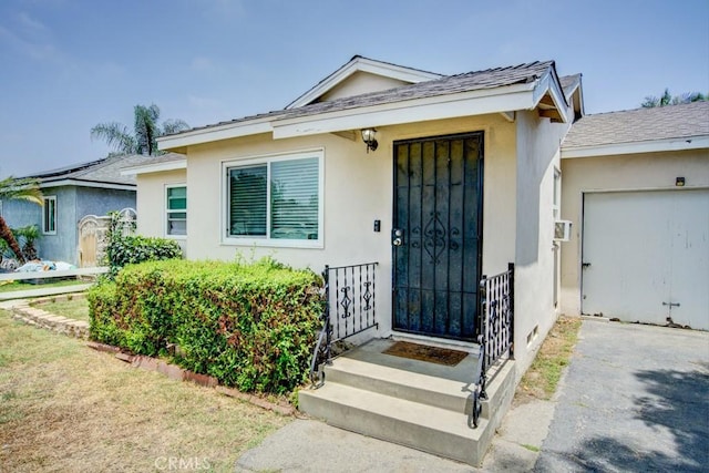12029 Greyford St, Whittier, CA 90606 - property entrance featuring stucco siding and an attached garage