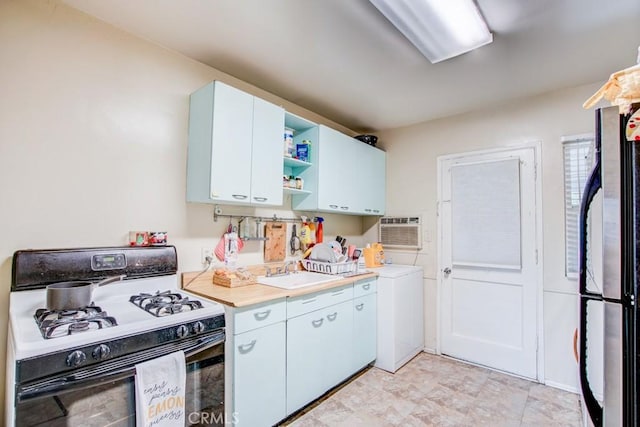12029 Greyford St, Whittier, CA 90606 - kitchen with gas range gas stove, freestanding refrigerator, open shelves, light countertops, and a wall unit AC