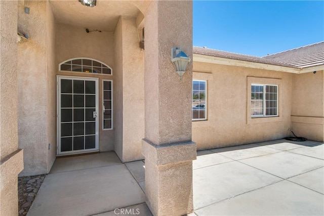 11471 Azure View Rd, Pinon Hills, CA 92372 - view of exterior entry with stucco siding and a patio area