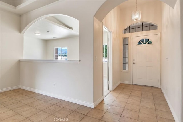 11471 Azure View Rd, Pinon Hills, CA 92372 - entrance foyer with light tile patterned floors, arched walkways, and a chandelier
