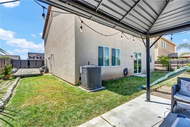 2146 N Rinaldi Ct, Visalia, CA 93291 - back of property with stucco siding, a deck, and a patio