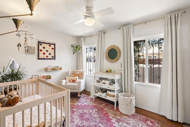 205 C St, Chula Vista, CA 91910 - bedroom with a crib, wood finished floors, and ceiling fan
