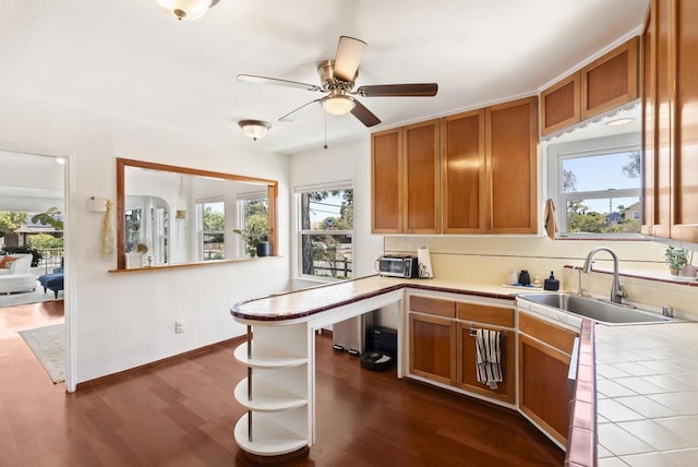 205 C St, Chula Vista, CA 91910 - kitchen featuring tile countertops, dark wood-style floors, plenty of natural light, and brown cabinetry