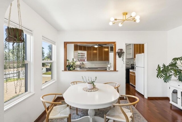 205 C St, Chula Vista, CA 91910 - dining room with dark wood-style flooring and a chandelier