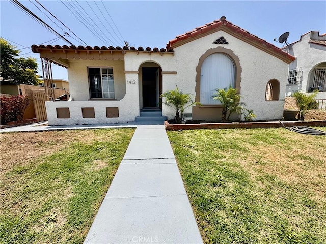 1412 W 89th St, Los Angeles, CA 90047 - mediterranean / spanish house featuring stucco siding and a tiled roof