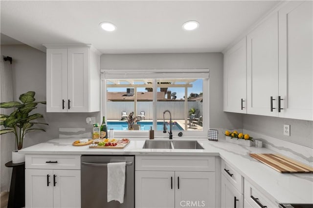 2433 Carlsbad Cir, Hemet, CA 92545 - kitchen with stainless steel dishwasher, white cabinetry, recessed lighting, and light stone countertops
