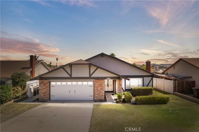 2433 Carlsbad Cir, Hemet, CA 92545 - view of front facade with an attached garage, concrete driveway, stucco siding, and brick siding