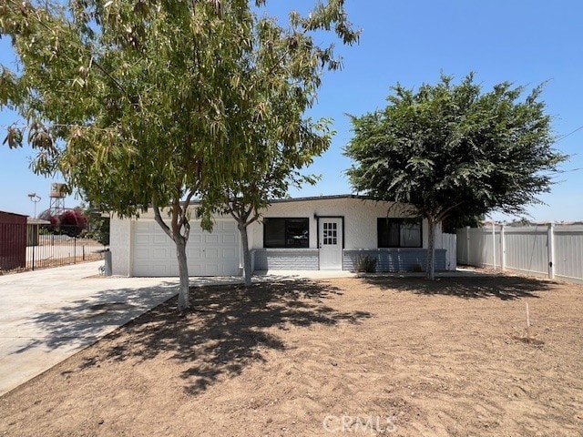 14421 Chandler St, Eastvale, CA 92880 - view of front of property with driveway, stucco siding, and a garage