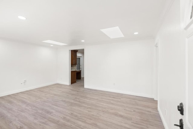 12405 Royal Rd, El Cajon, CA 92021 - spare room featuring a skylight, recessed lighting, light wood-style flooring, and ornamental molding
