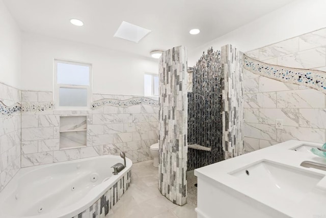 12405 Royal Rd, El Cajon, CA 92021 - bathroom with tile walls, a tub with jets, double vanity, a wainscoted wall, and marble finish flooring