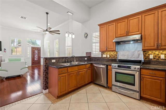 5517 Welland Ave Unit B, Temple City, CA 91780 - kitchen featuring appliances with stainless steel finishes, under cabinet range hood, brown cabinetry, crown molding, and lofted ceiling