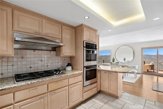1324 Pitcairn Pl, Laguna Beach, CA 92651 - kitchen featuring stainless steel appliances, light brown cabinetry, under cabinet range hood, recessed lighting, and backsplash
