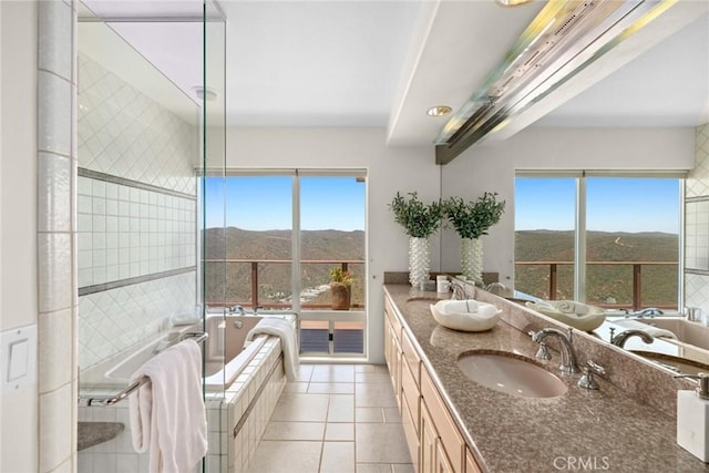 1324 Pitcairn Pl, Laguna Beach, CA 92651 - full bathroom with a mountain view, double vanity, tiled tub, and plenty of natural light