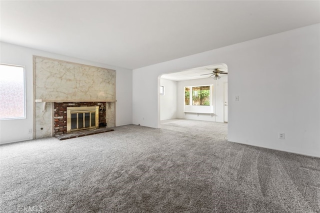 9726 Kimberly Ave, Montclair, CA 91763 - unfurnished living room with carpet flooring, ceiling fan, and a brick fireplace
