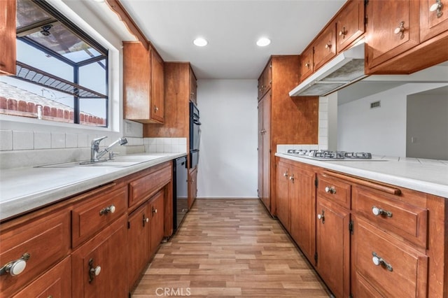 9726 Kimberly Ave, Montclair, CA 91763 - kitchen featuring stainless steel appliances, brown cabinets, light wood-style floors, light countertops, and recessed lighting